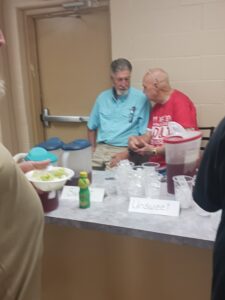 Two Men Talking at a Dinner